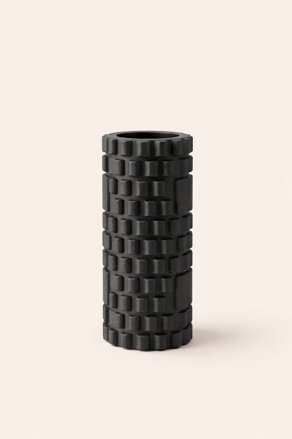 Foam roller used for muscle recovery showing cylindrical design and textured surface